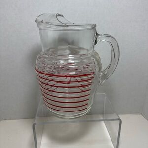 Vintage clear ice lip pitcher with red stripes.